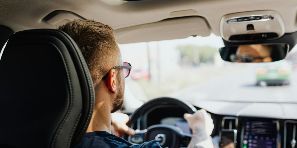 Man driving a car, seen from the passenger seat, like during a driving lesson in France